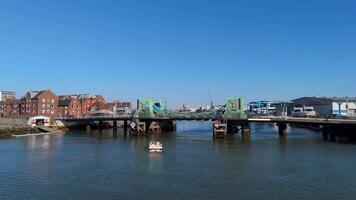 28 April 2025 Poole, Uk. Poole lifting bridge opening sequence with boat passing by video