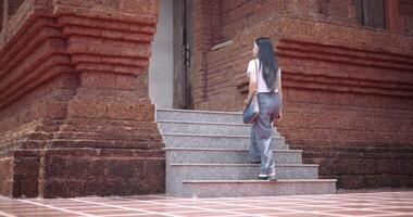 Handheld shot, Solo tourist enjoy strolling around to appreciate the serene surroundings and the cultural richness of the place. Traveling and vacation concept video