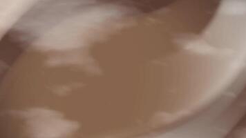 Blurry white cloud over brown land suitable for nature concept designs, neutral backgrounds, or abstract environmental themes in artistic projects. video