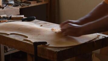 Luthier working in the cover of a violoncello video