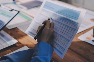 A business owner is using a calculator to calculate the cost of a new product photo