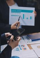 Business people using mobile devices to analyze data photo