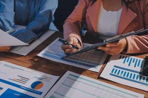 Two business people are working on a document and papers photo
