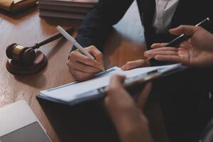 A lawyer writing on a notepad with a pen photo