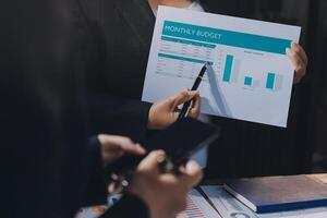 Businessman holding a paper with a graph on it photo