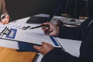 A man signing a contract with a woman at a desk photo