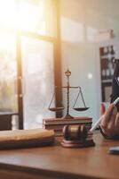 Lawyer in office with scales of justice and scales of justice photo