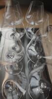 Clean wine glasses are on the table of a special wine cabinet, stylish table setting, ice, bottle of sparkling wine, light from window, decanter and degasser video