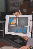 A person holding a clipboard with a graph on it photo