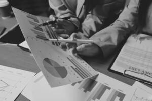 Two people are looking at graphs on papers photo
