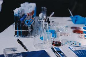 A table with a glass beaker, a flask and a bottle photo
