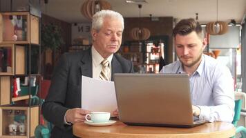 Dynamic business meeting between partners at a cozy cafe video