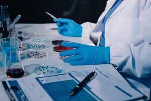 A person in a lab coat and gloves is working on a test photo