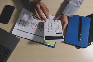 A person is using a calculator to calculate the numbers on a graph photo