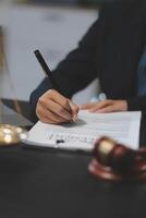 A person signing a contract with a pen and paper photo