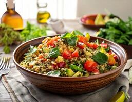 A bowl of quinoa salad with vegetables and tomatoes photo