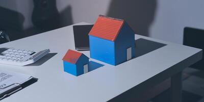 A small house model sits on a desk photo