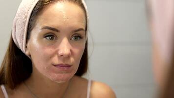 Woman Rinsing Face with Water After Cleanser in Skincare Routine video