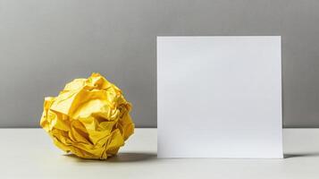 Minimalist concept with crumpled yellow paper and blank square page for creativity and design. Symbolism of fresh starts photo