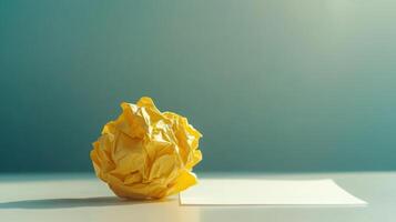Crumpled yellow paper on a table against gradient background for minimalist design. Symbolism of fresh starts photo
