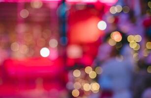 Abstract bokeh light effect with vibrant red and pink color blurred image background photo