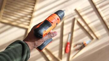 Building wooden structures with a cordless drill in a workshop video
