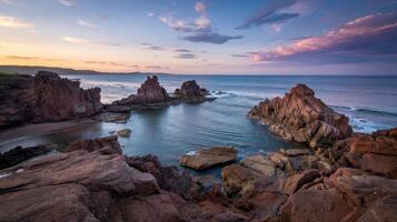 Coastal magic unfolds with jagged rocks and vibrant sunset over tranquil waters photo