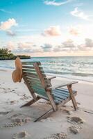 Sunlit retreat on a tranquil beach with weathered wooden chair awaiting relaxation photo