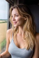 Woman enjoying a tranquil train journey while gazing at beautiful summer fields passing by, lost in thought and serene moment photo