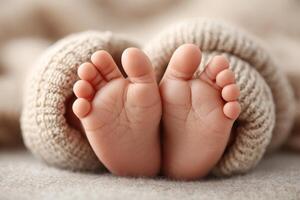 Delicate baby feet resting peacefully on a soft blanket in warm natural light photo