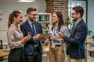 Professionals engage in lively conversation while networking at a modern office space during a team meeting photo