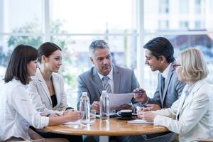 Engaging business discussion among professionals in bright modern office setting photo