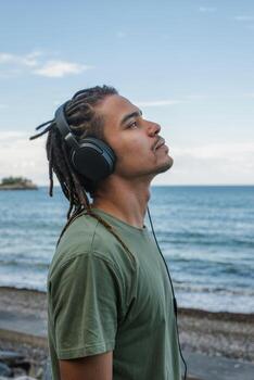 Listening to ocean waves while enjoying music on a beach with a clear sky in the late afternoon photo