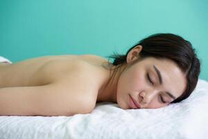 Relaxation and rejuvenation captured in a serene spa setting with a peaceful Asian woman enjoying tranquility photo