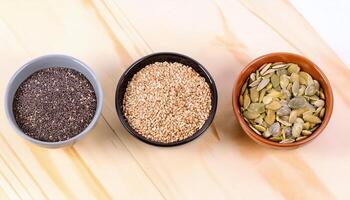 Assorted Seeds in Bowls on Rustic Table photo