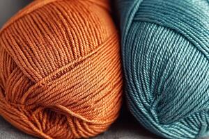 Colorful close-up of orange and teal blue yarns showcasing texture and creativity in knitting or crocheting photo