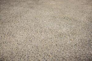 Detailed view of a textured surface made of small, evenly distributed pebbles, likely part of a flooring or underfloor heating construction process. photo