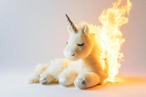 A white unicorn is sitting on a white surface with fire coming out of its mouth photo