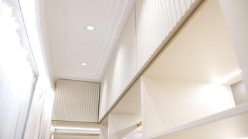 Ceiling view of modern wardrobe with white panels and spotlights video