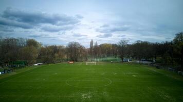 Large, empty soccer field with a cloudy sky in the background photo
