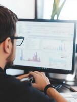 Business Analyst Working with Data and Charts on a Computer Screen photo