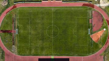 Aerial view of empty football field with running track photo