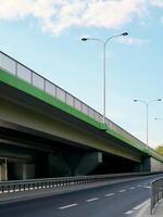 Bridge with a green railing and a street with a white line photo