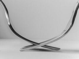 Two forks are crossed over each other, creating unique and interesting design photo