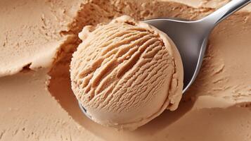 Creamy caramel ice cream scoop resting on a spoon against a smooth background of ice cream texture photo