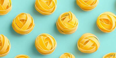 Rotini pasta arranged in playful spirals on a vibrant turquoise background showcasing culinary creativity and vibrant food presentation photo