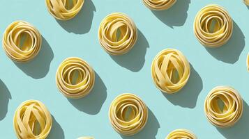 Freshly rolled pasta arranged on a vibrant blue background showcasing various shapes and textures in a culinary display photo