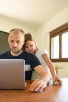 Daughter distracts working father with a toy. A heartwarming glimpse of remote parenting. photo