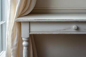 A white table with a drawer and a curtain photo