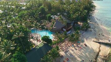 Aerial view of a tourist beach and hotel swimming pool in Punta Cana video